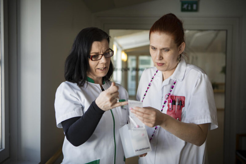 Sairaanhoitaja ja apteekkiproviisori tarkastelevat annosjakelun pusseja. Kuva Eeva Anundi.